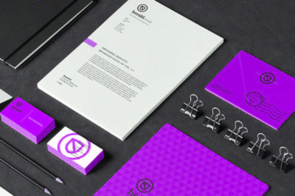 Purple branded stationery mockup with business cards, letterhead, envelope and binder clips on dark surface